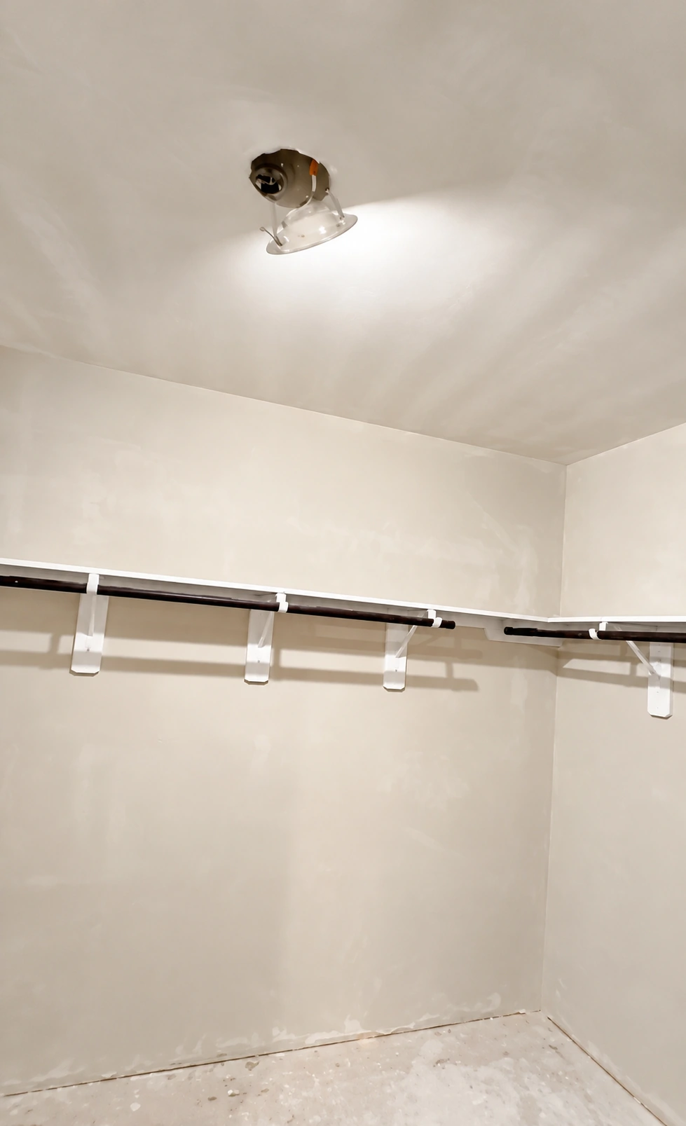 Closet walls and ceiling during finishing, with shelf supports in place