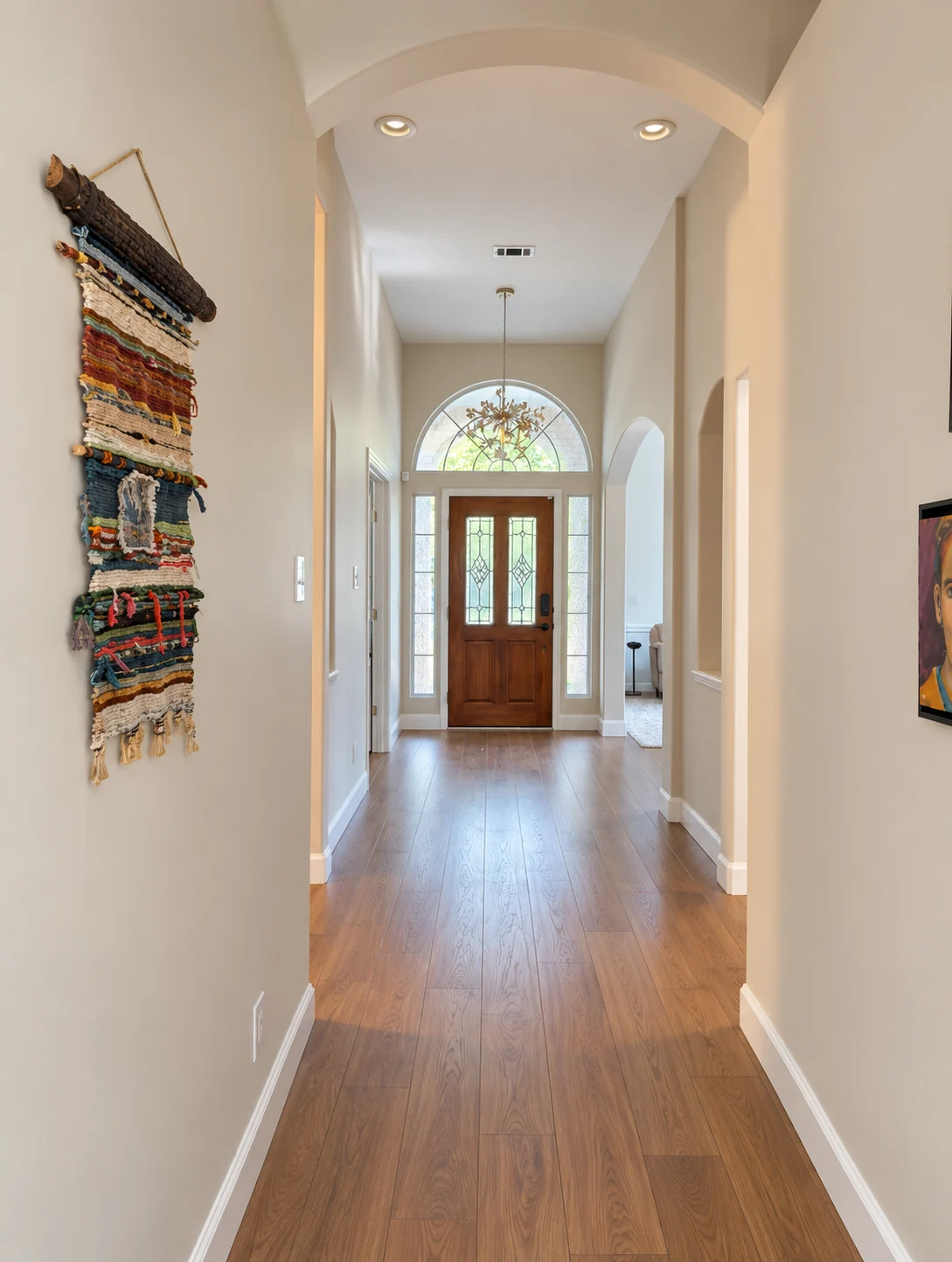 Renovated hallway with engineered hardwood flooring and freshly painted walls