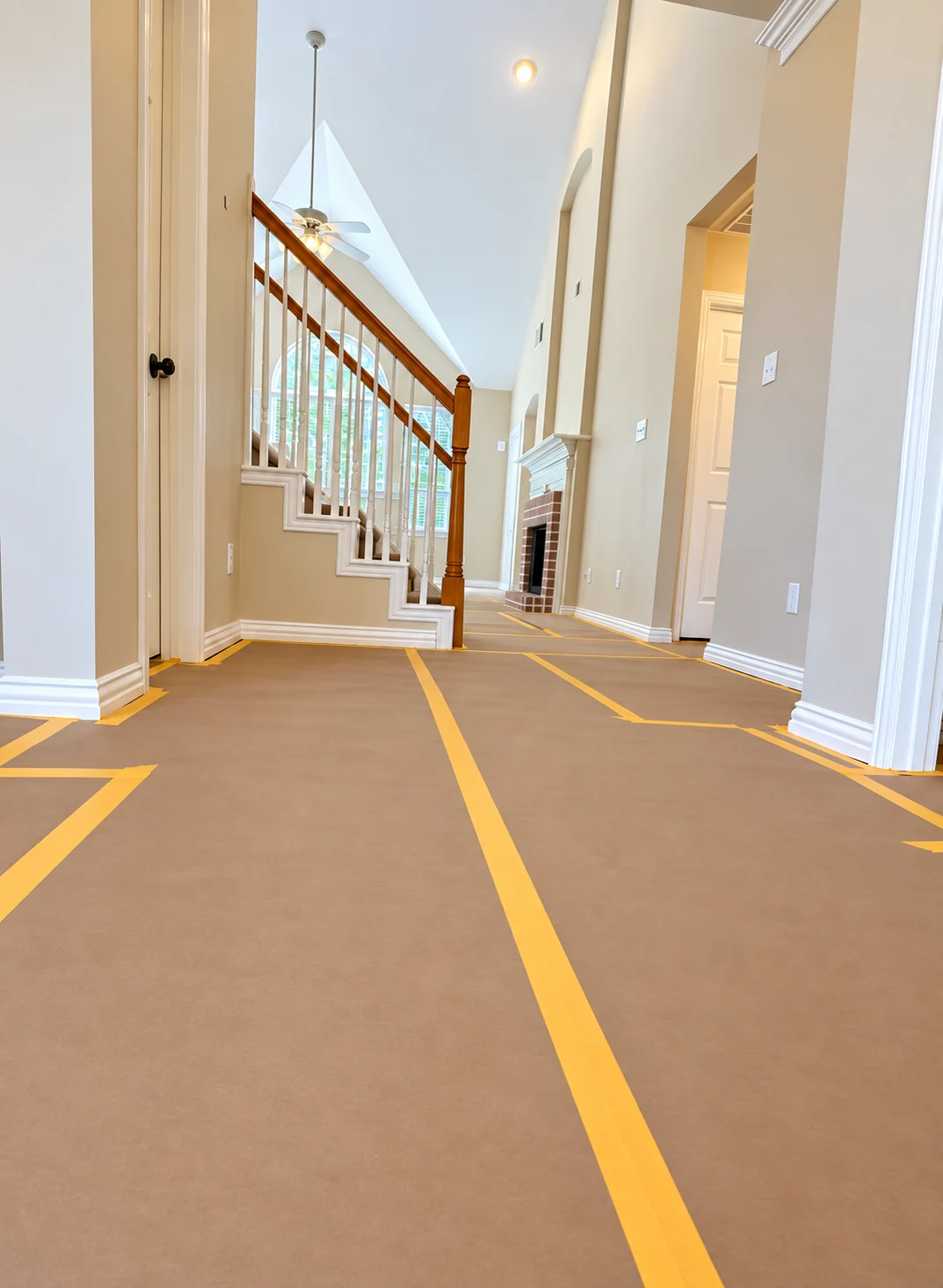 Floor fully protected with brown paper and taped seams around stairs and doorways