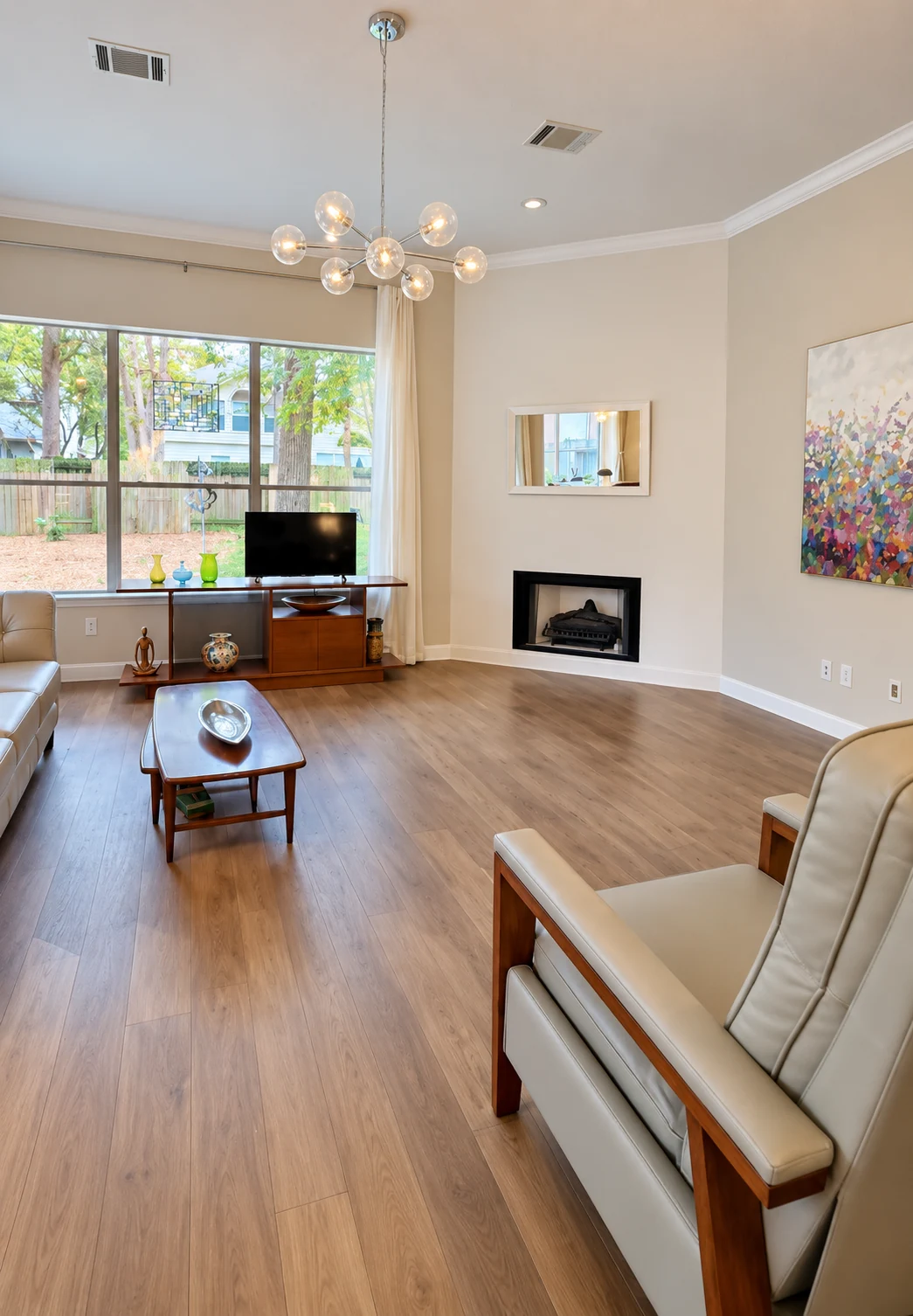 Living room with engineered hardwood floors, painted walls and updated fireplace